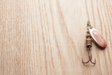 Fishing spoon on wooden table