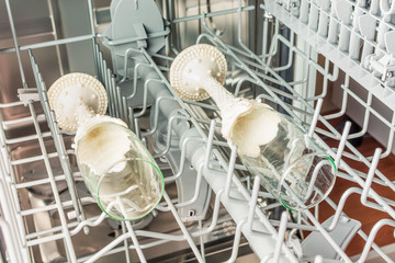 Glasses of champagne are in the middle compartment of the dishwasher