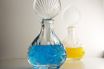 Glass flasks of blue and yellow essence