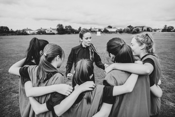 Rugby players and their coach gathering before a match