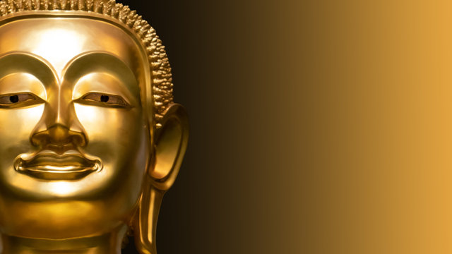 Golden Buddha face on golden abstract background