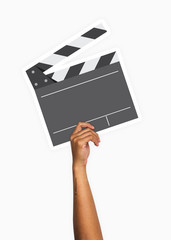 Hand holding a clapperboard prop