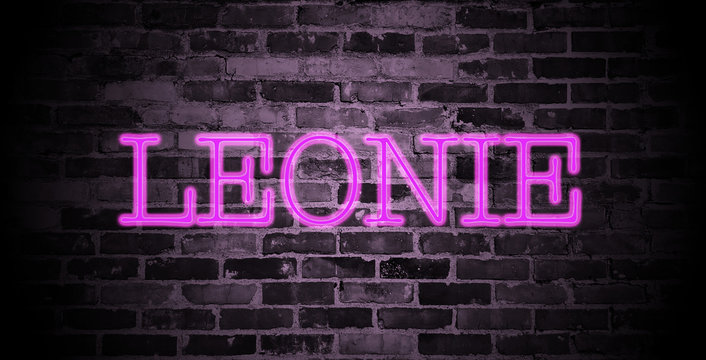 first name Leonie in pink neon on brick wall