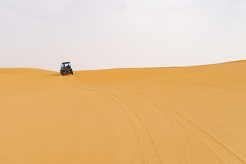 Fototapeta na wymiar 4x4 at the moroccan desert dunes