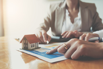 experienced real estate agent showing house model to client and ready to sign contract