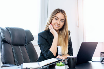 Happy businesswoman working on the computer.