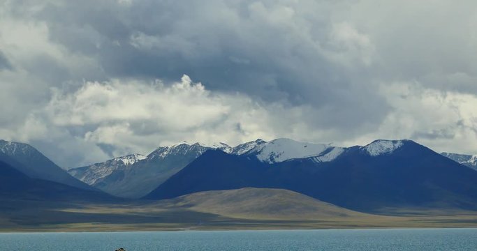4k time lapse of huge clouds mass rolling over lake namtso & Tanggula snow mountain peak,tibet mansarovar,Tibet's second largest lake,is the third largest saltwater lake in China.