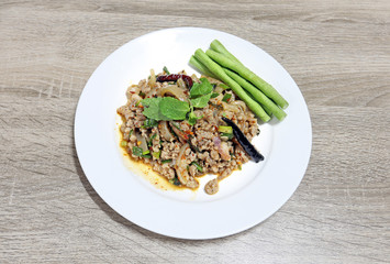 Spicy minced pork salad thai tradition food on wooden background with copy space
