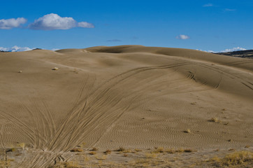 The dirt road over the sand dunes in the great basin desert. 