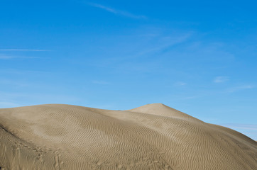 The sand dunes at the cool blue autumn sky of the basin. 