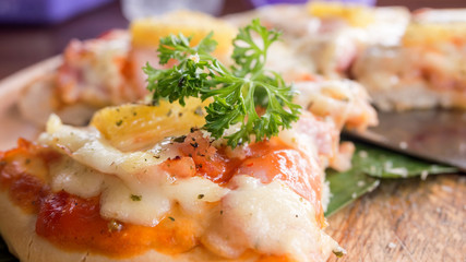 close up of Hawaiian pizza juicy pineapple chunks ham bits melted mozzarella cheese