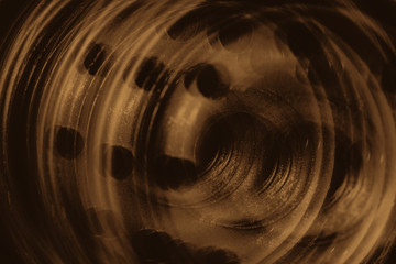 Monochrome multi exposition background of oil filter close up. Artwork from auto part in macro photography. Sepia tones.