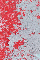 red peeling paint on the old rough concrete surface