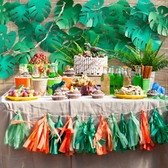 candy bar on children's birthday. cake with dinosaur and sweets,