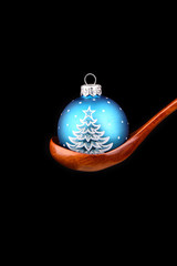 Blue ball with a Christmas tree pattern Christmas toy on a woode