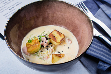 Delicious mushrooms soup puree in bowl on table. Scandinavian cuisine. Close-up
