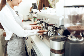 Close up of female barista preparing coffee