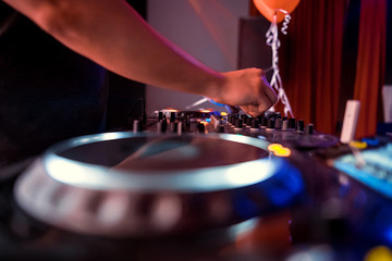 Dj playing the track in the nightclub at a party