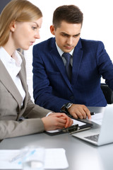 Fototapeta premium Business people using laptop pc while discussing project in office. Successful meeting and negotiation concepts