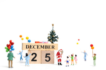 Miniature people : Santa Claus holding gift for happy family , Christmas and Happy New Year concept.