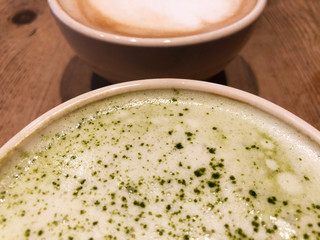 Half Cup Of Matcha Tea Latte And Cafe Latte