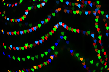 Abstract bokeh lights in the heart shape with isolated black in background