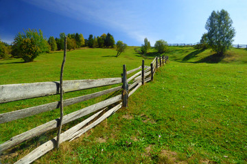 Long wooden hill side fence