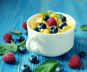 Healthy eating, food  and diet concept - Cornflakes with berries
