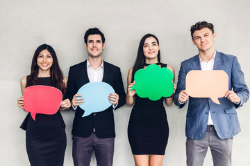 Group of business people holding a speech bubble icon