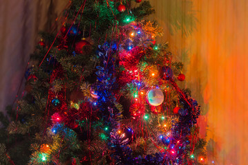 Fragment of the artificial Christmas tree with lights decoration