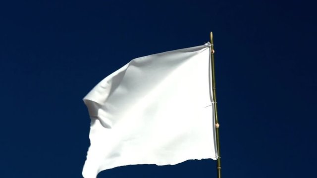 White flag waving in the blue sky 