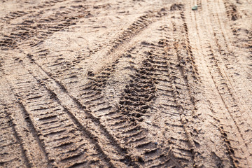 motorcycle and car tire track print on sand or mud with selective focus