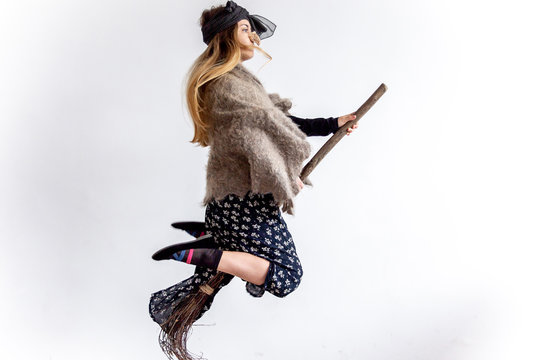 A young woman wearing a witch costume