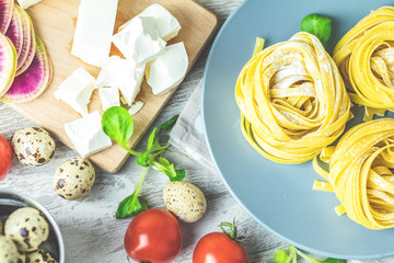 Raw homemade Italian typical pasta linguine noodles on plate