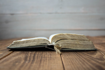 a open old bible on wooden background