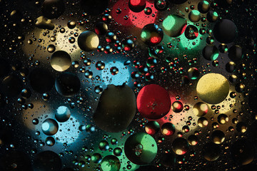 water drops on glass with colorful background, close-up 