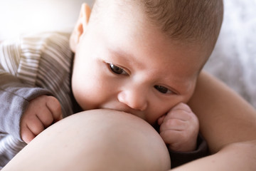 mother breastfeeding and hugging baby, close-up breast. Mom breast feeding her newborn child....