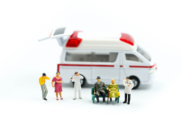 Miniature people : Doctor and Paramedic attending to patient in ambulance,Medicine ambulance concept