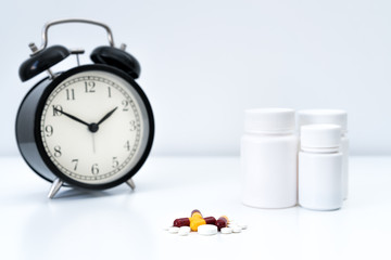 Alarm clock tablet capsules and a glass of water