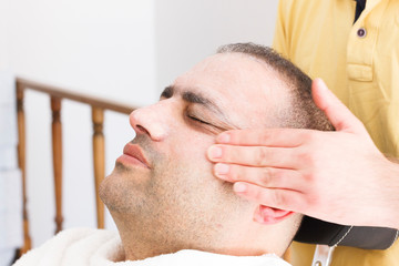 Fototapeta premium Facial massage for man in barber shop in Turkey