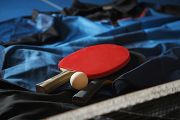 uniform for playing table tennis with red racket and white ball