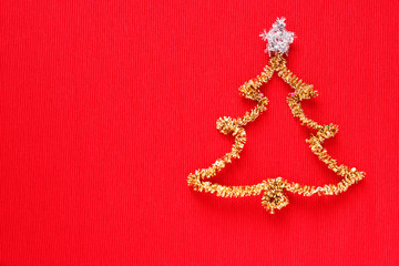 Gold christmas tree with colored balls on red background