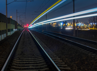 Fototapeta na wymiar Train light trail with yellow and blue light, long exposure