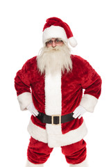 portrait of old saint nick wearing sunglasses holding hips