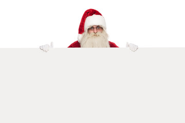 saint nick wearing sunglasses and santa costume holds white billboard