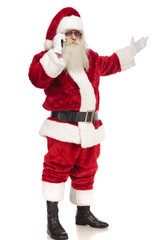 santa claus speaks on the phone and presents to side