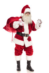 happy santa claus holding red bag and ringing his bell