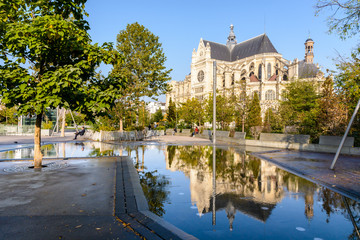 The church of Saint-Eustache in Les Halles district in Paris, France, reflecting in a reflection pool.