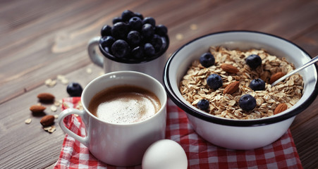 A healthy breakfast - Oatmeal porridge, boiled egg, milk, fresh berries and coffee. A great start to a new day.
