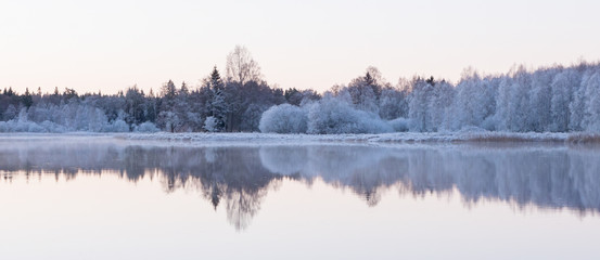 Fototapeta premium Frosty river landscape in sunrise